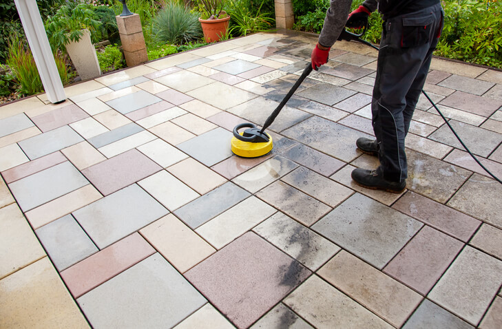 Person worker cleaning the outdoors floor.