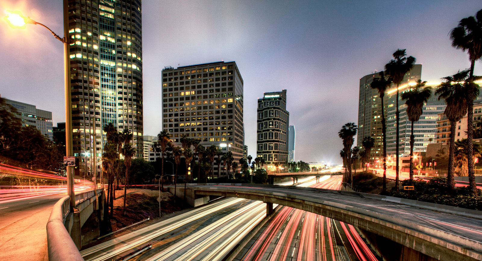 Long exposure image of a highway with blurred lights from cars.